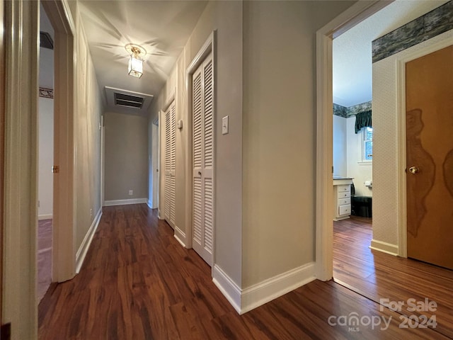 hallway with dark wood-type flooring