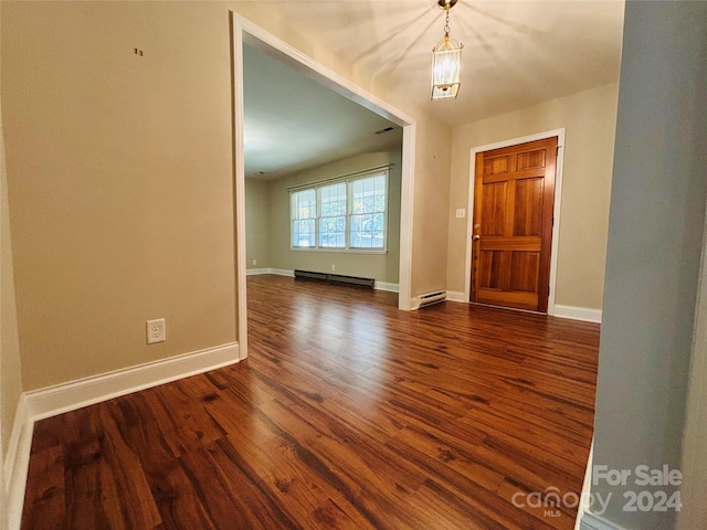 entrance foyer featuring baseboard heating, a chandelier, and dark hardwood / wood-style flooring