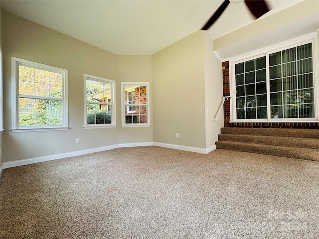 carpeted spare room with ceiling fan