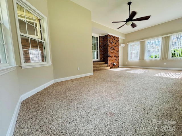 unfurnished living room with carpet and ceiling fan