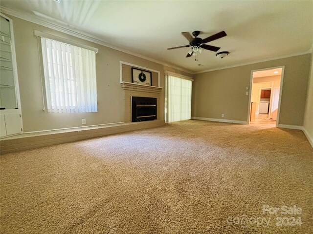 unfurnished living room with crown molding, carpet, and ceiling fan