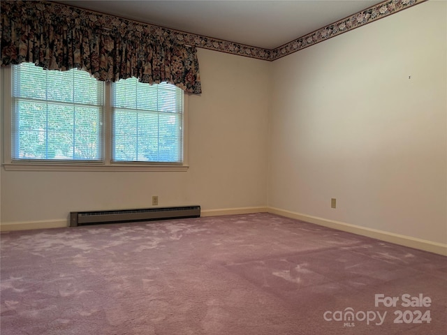 carpeted spare room with baseboard heating