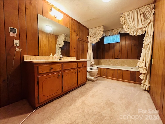 bathroom featuring vanity, a tub, toilet, and wooden walls