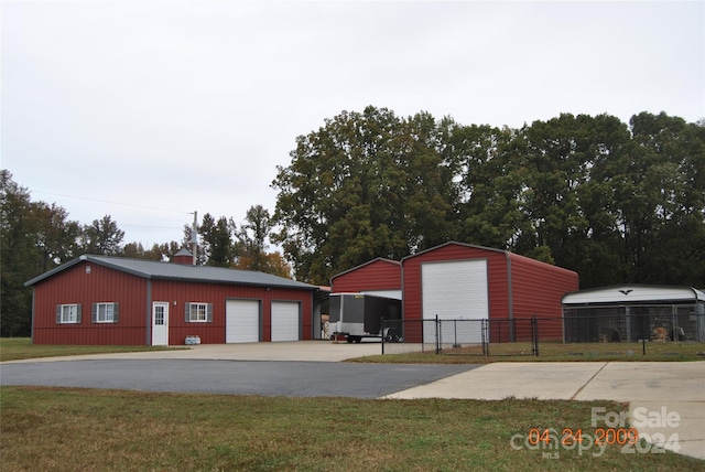 view of outdoor structure featuring a garage and a lawn