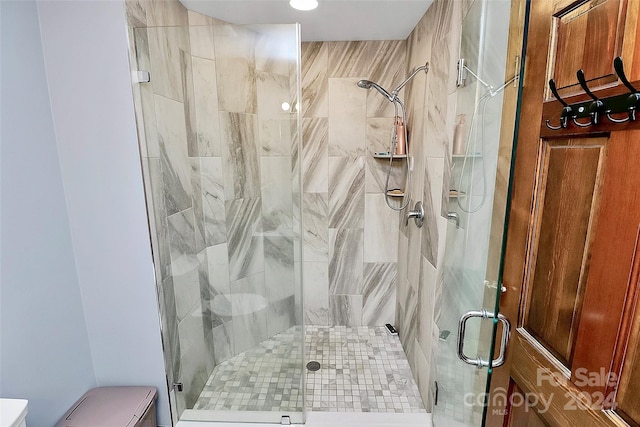 bathroom featuring a shower with shower door