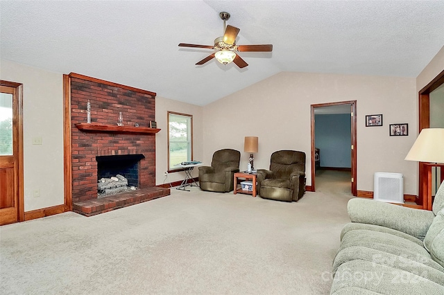 living room featuring lofted ceiling, a textured ceiling, light carpet, ceiling fan, and a fireplace