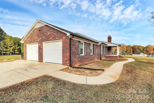 view of property exterior with a garage and a lawn