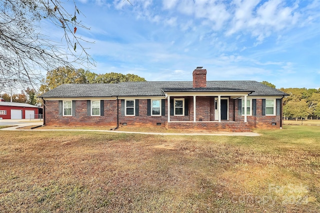 single story home featuring covered porch, a garage, and a front yard