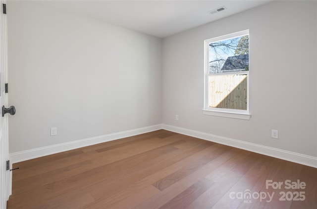 spare room with hardwood / wood-style floors