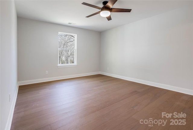 empty room featuring ceiling fan and hardwood / wood-style floors