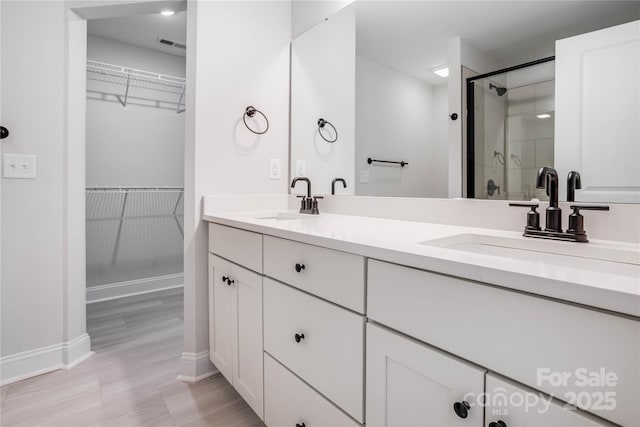 bathroom with walk in shower and vanity