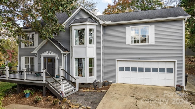 view of front of house with a wooden deck and a garage