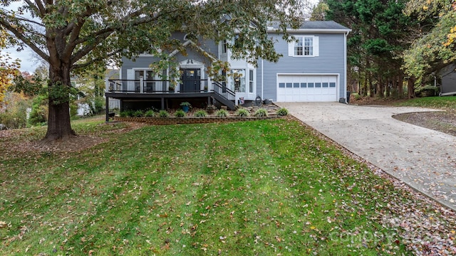 view of front facade with a front yard, a garage, and a deck