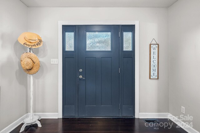 entryway with dark hardwood / wood-style floors