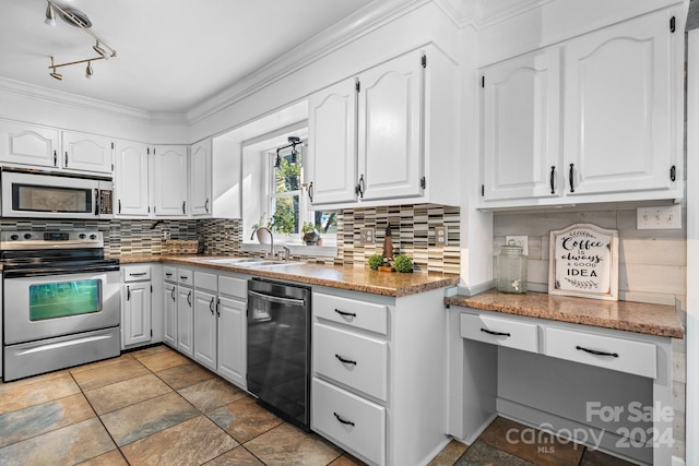 kitchen featuring backsplash, crown molding, appliances with stainless steel finishes, and white cabinets