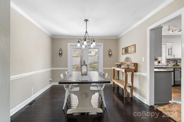 dining area featuring a notable chandelier, ornamental molding, and dark hardwood / wood-style flooring