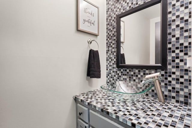 bathroom featuring vanity and decorative backsplash