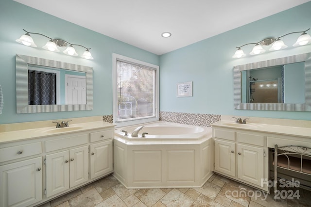 bathroom featuring vanity and separate shower and tub