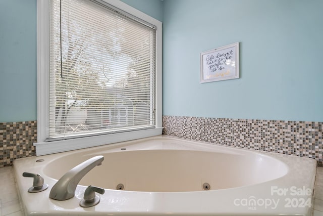 bathroom with plenty of natural light and a washtub