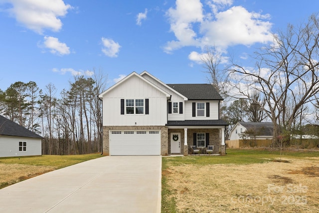 view of front facade with a garage, a porch, and a front lawn