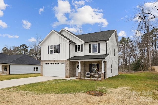 view of front of house featuring a garage, a front yard, and covered porch