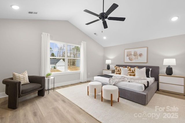 bedroom with ceiling fan, lofted ceiling, and light hardwood / wood-style floors