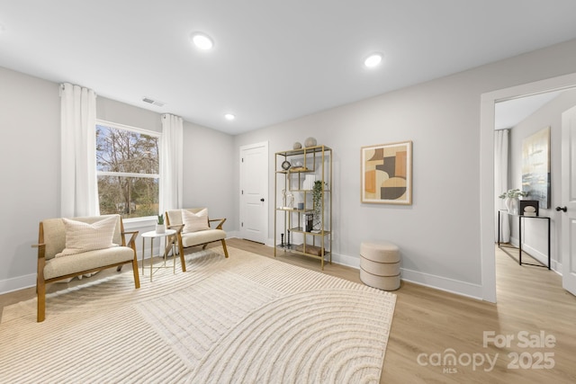 living area with light hardwood / wood-style flooring