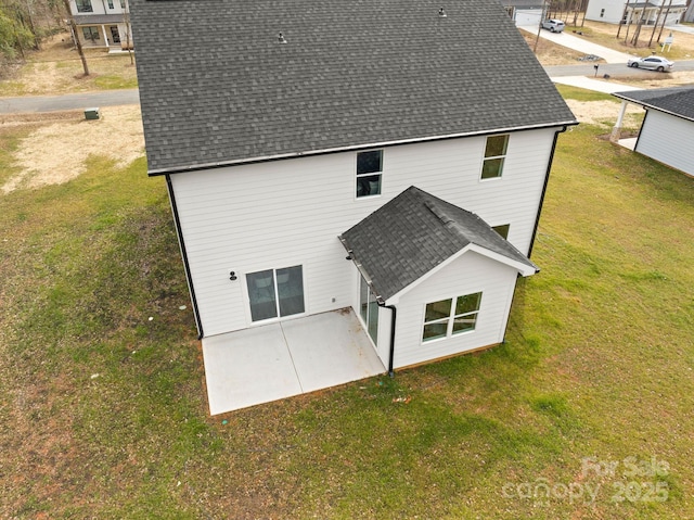 back of house with a yard and a patio