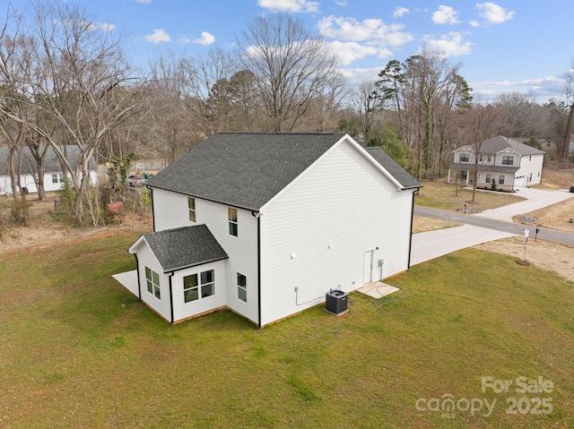 view of home's exterior featuring a yard and central AC