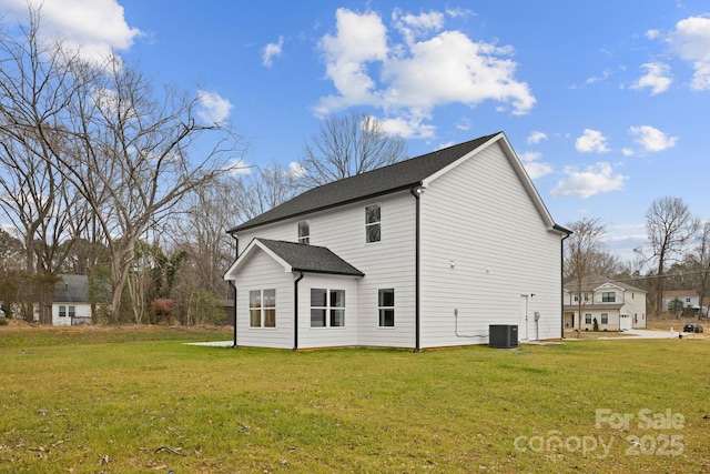 back of property featuring cooling unit and a yard