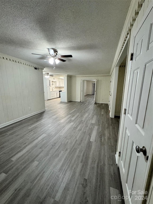 2123 Carriage Woods Ln, Kannapolis, NC 28081 - unfurnished living room with a ceiling fan, dark wood-style flooring, a textured ceiling, and baseboards
