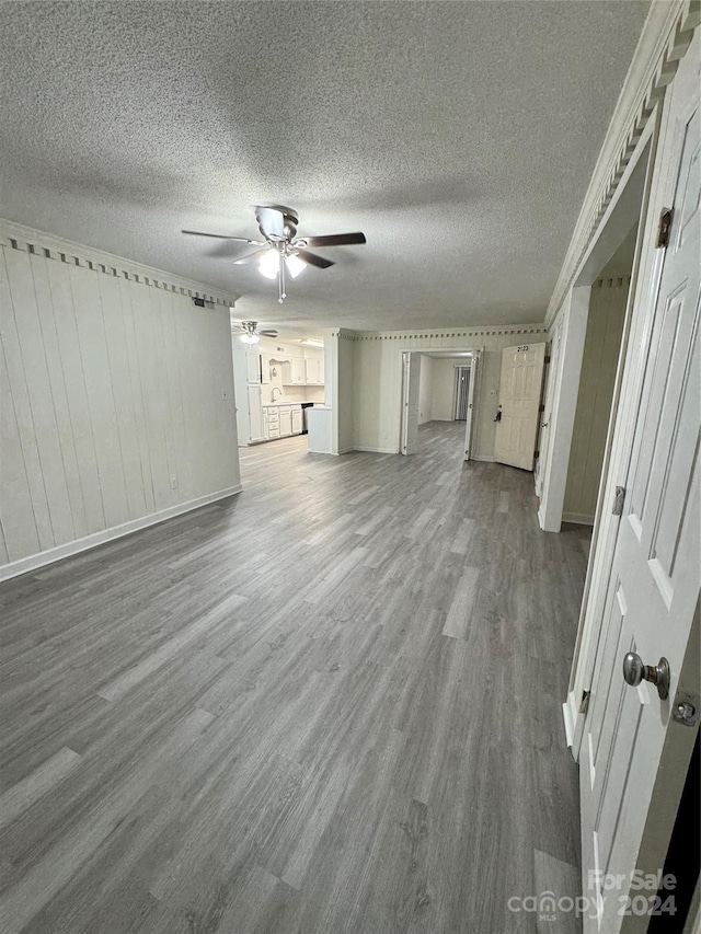 2123 Carriage Woods Ln, Kannapolis, NC 28081 - unfurnished living room featuring a ceiling fan, dark wood-type flooring, a textured ceiling, and baseboards