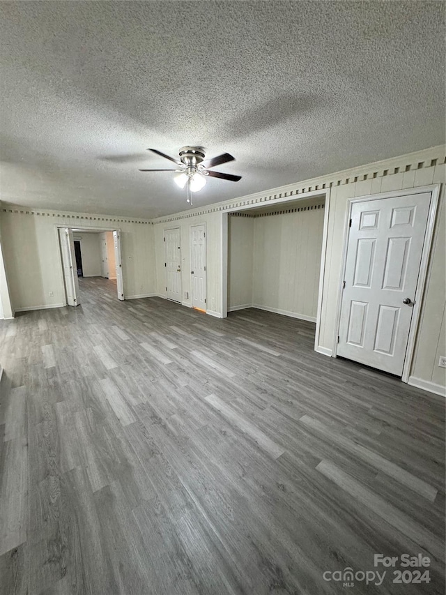 unfurnished bedroom with ceiling fan, a textured ceiling, and hardwood / wood-style floors