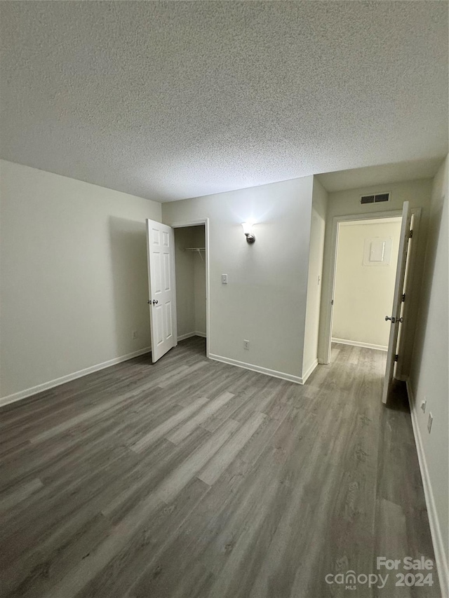 empty room featuring hardwood / wood-style flooring and a textured ceiling