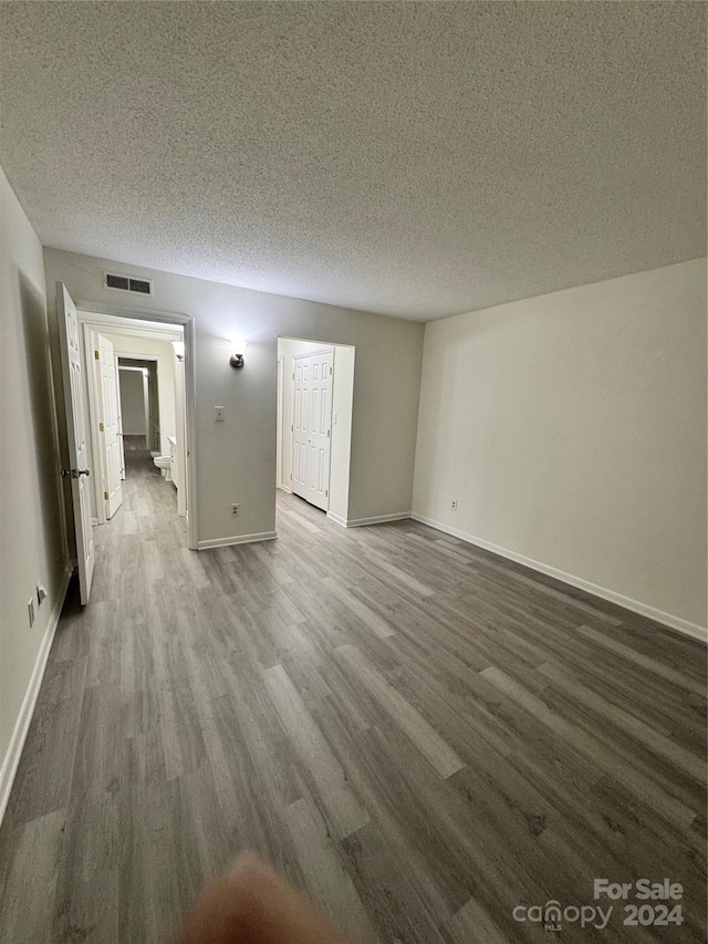 empty room featuring hardwood / wood-style floors and a textured ceiling