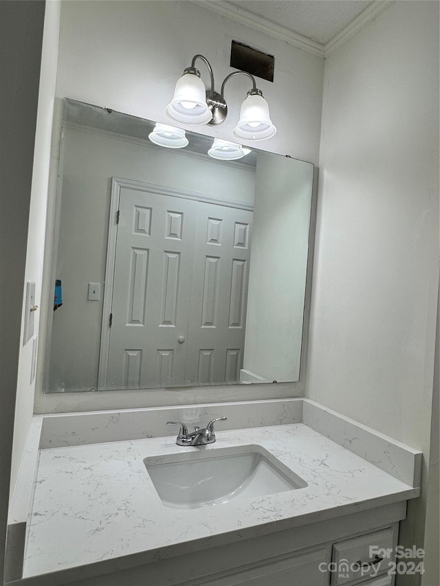 bathroom featuring vanity and ornamental molding