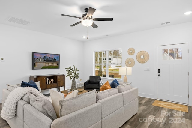 living room with dark hardwood / wood-style floors and ceiling fan