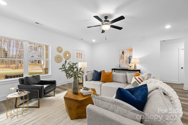 living room featuring ceiling fan and light hardwood / wood-style floors