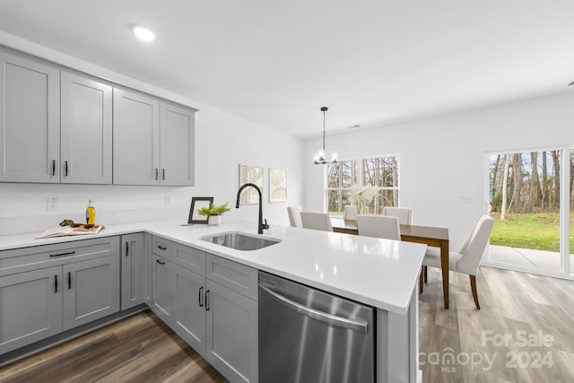 kitchen featuring kitchen peninsula, sink, stainless steel dishwasher, and plenty of natural light