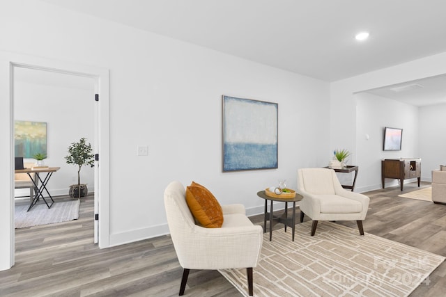 sitting room with hardwood / wood-style flooring