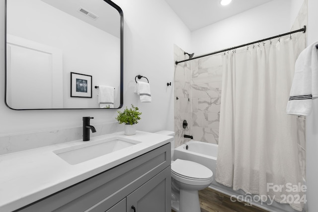 full bathroom with vanity, shower / bathtub combination with curtain, wood-type flooring, and toilet