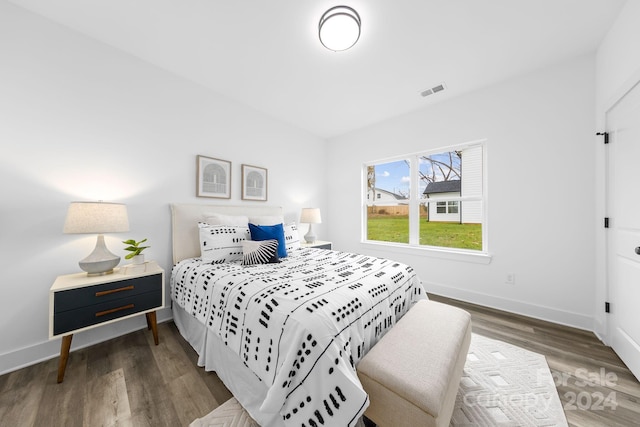 bedroom with dark wood-type flooring