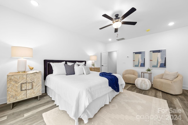 bedroom with ceiling fan and hardwood / wood-style floors