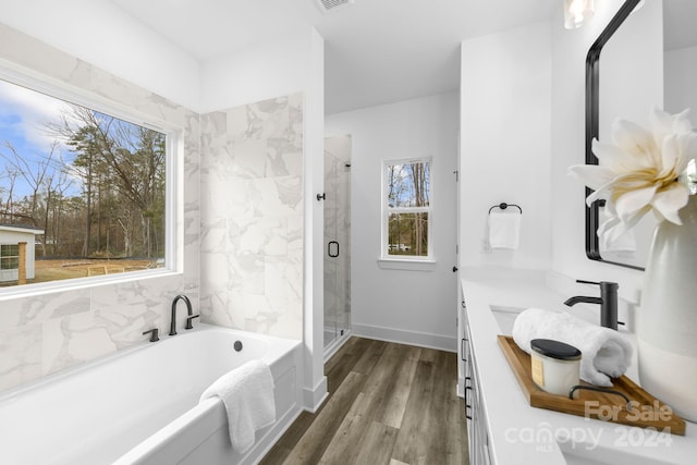 bathroom with vanity, wood-type flooring, and shower with separate bathtub