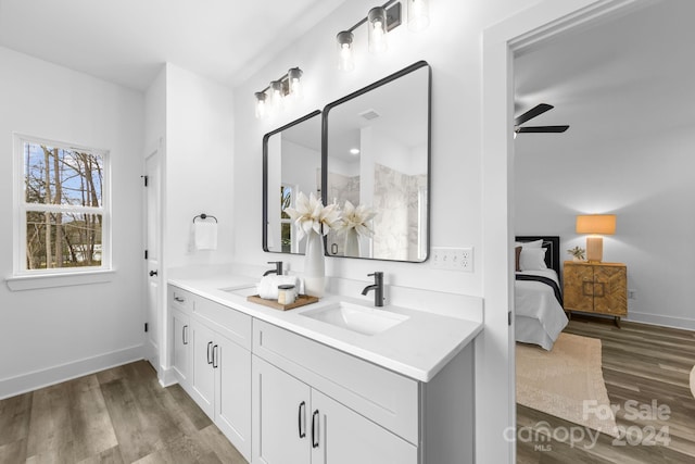 bathroom with hardwood / wood-style floors, ceiling fan, and vanity