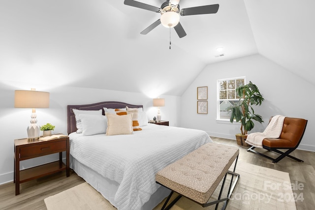 bedroom featuring light wood-type flooring, ceiling fan, and lofted ceiling