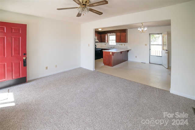 unfurnished living room featuring sink and ceiling fan with notable chandelier