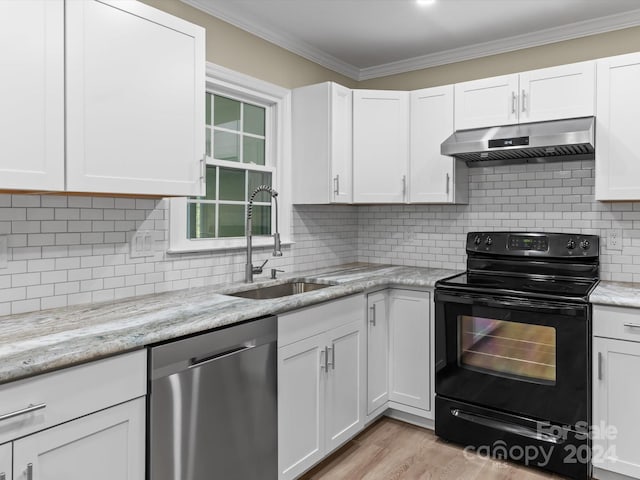 kitchen with electric range, white cabinetry, dishwasher, and sink