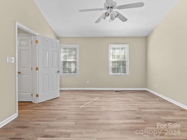 unfurnished room featuring vaulted ceiling, light wood-type flooring, and ceiling fan