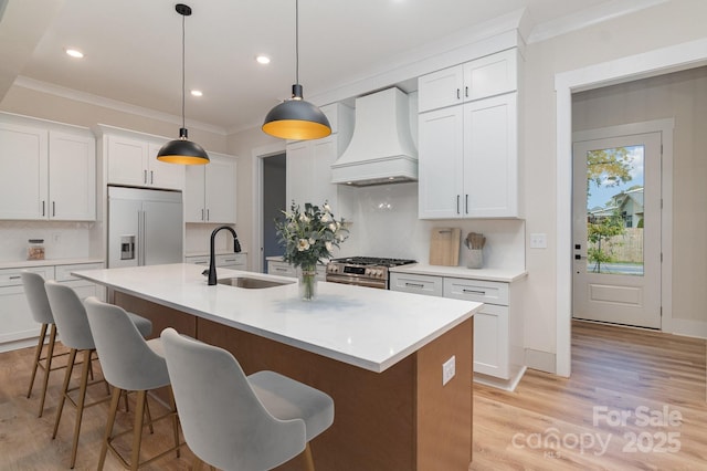 kitchen featuring sink, white cabinets, appliances with stainless steel finishes, and custom exhaust hood